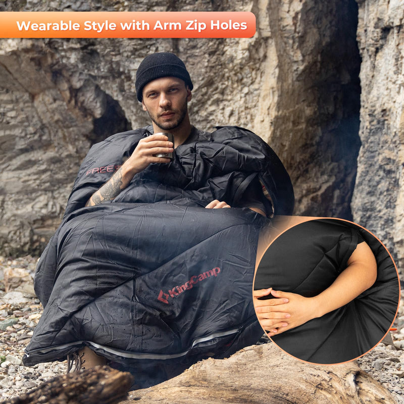 Load image into Gallery viewer, KingCamp FREESPACE 300 Wearable Sleeping Bag – Waterproof, Extra Wide Flannel Camping Sleeping Bag Person using a black wearable sleeping bag with arm zip holes in a natural setting.
